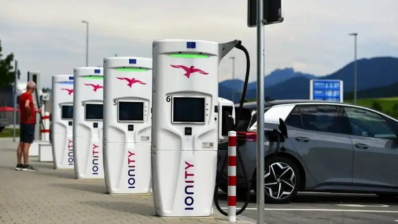 Public electric vehicle charging stations with cars plugged in