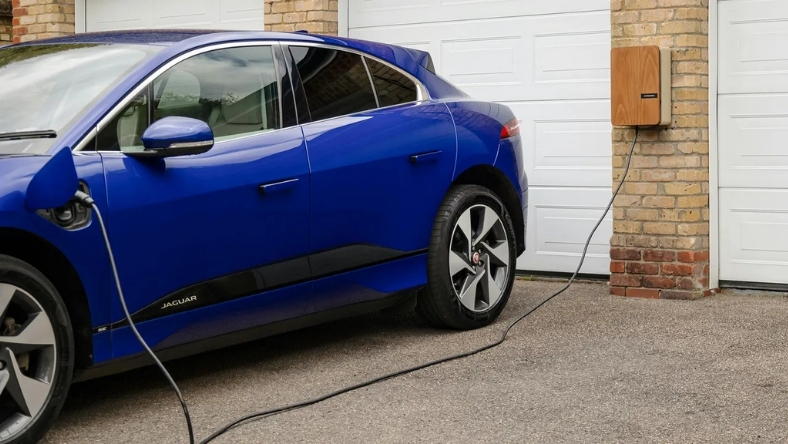 Electric car plugged into a wall-mounted EV charger